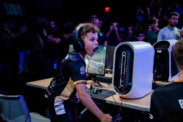 A boy cheering after winning a game.